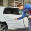 Man worker washing car on a car wash